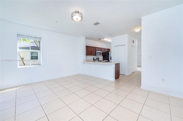 unfurnished living room featuring light tile patterned floors