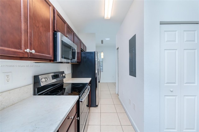 kitchen with light tile patterned floors, electric panel, and stainless steel appliances