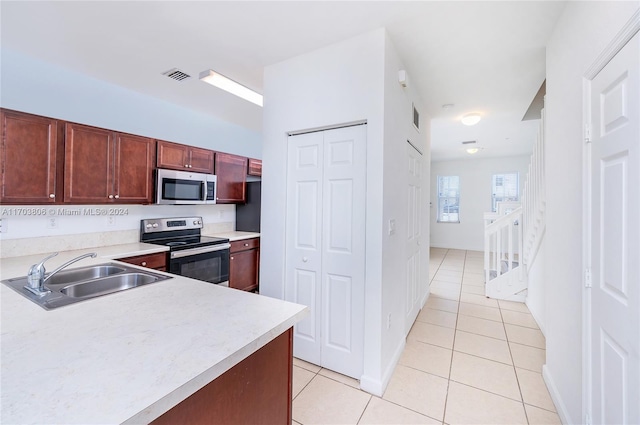 kitchen featuring light tile patterned floors, sink, and appliances with stainless steel finishes