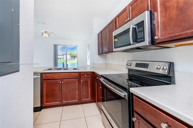 kitchen with sink, light tile patterned floors, and stainless steel appliances