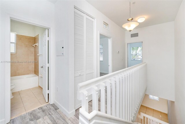 hall with tile patterned floors