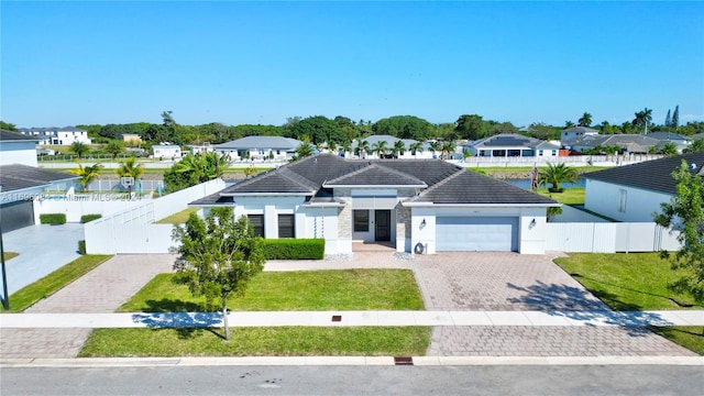 view of front facade with a garage and a front yard