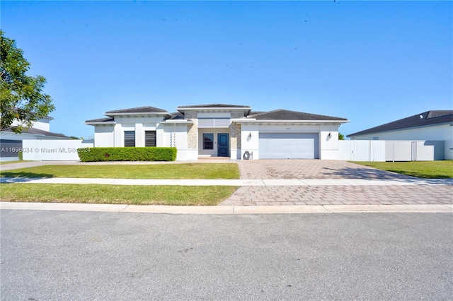 view of front of property with a front lawn and a garage