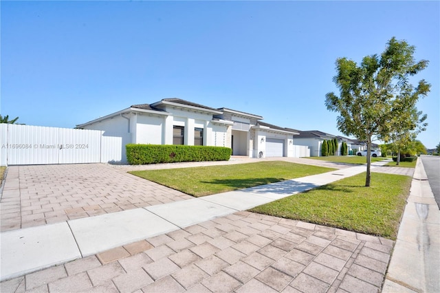 view of front of property featuring a front yard and a garage