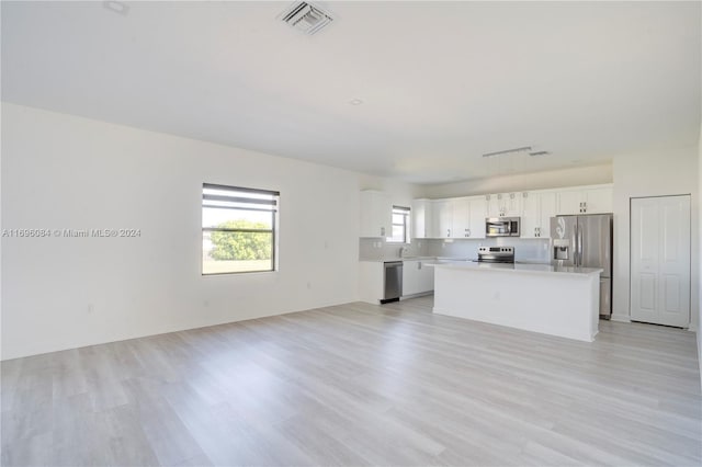 unfurnished living room with light hardwood / wood-style flooring