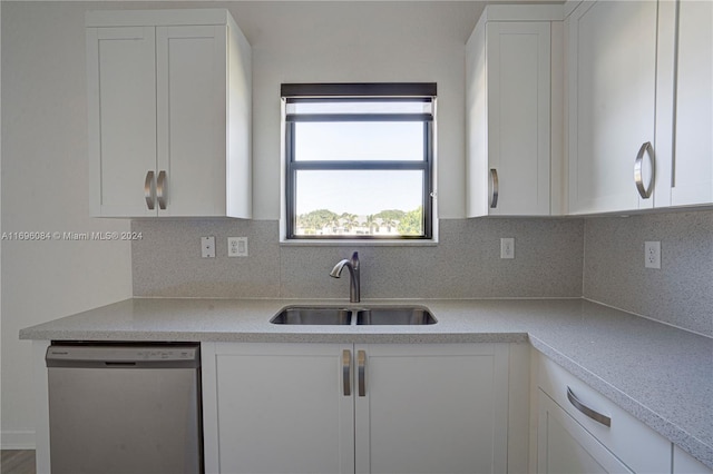 kitchen featuring white cabinetry, stainless steel dishwasher, and sink