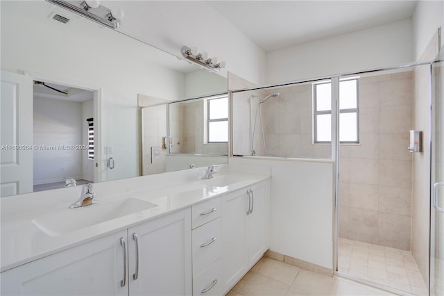 bathroom featuring vanity, tile patterned floors, and a shower with door