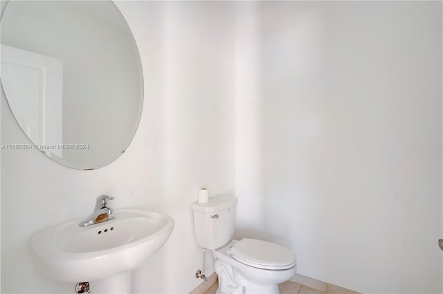 bathroom featuring tile patterned flooring, toilet, and sink