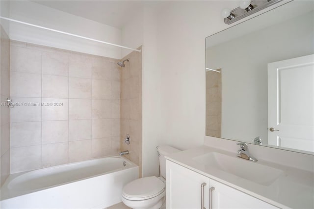 full bathroom with toilet, vanity, and tiled shower / bath