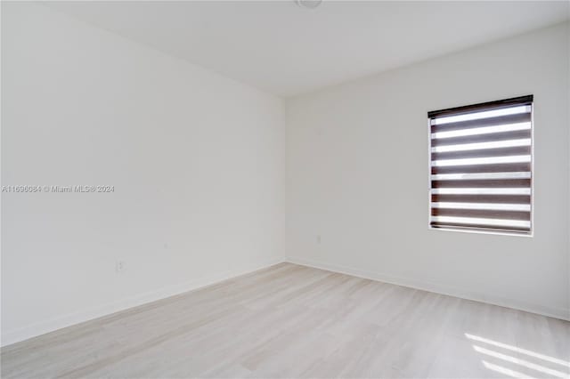 unfurnished room with light wood-type flooring