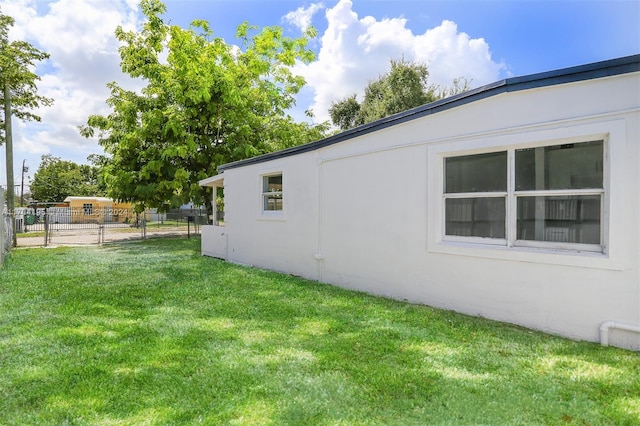 view of side of home with a lawn