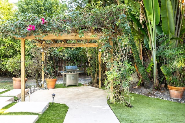 view of patio with a pergola and area for grilling