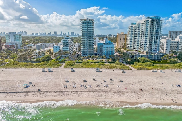 aerial view featuring a water view, a view of city, and a view of the beach