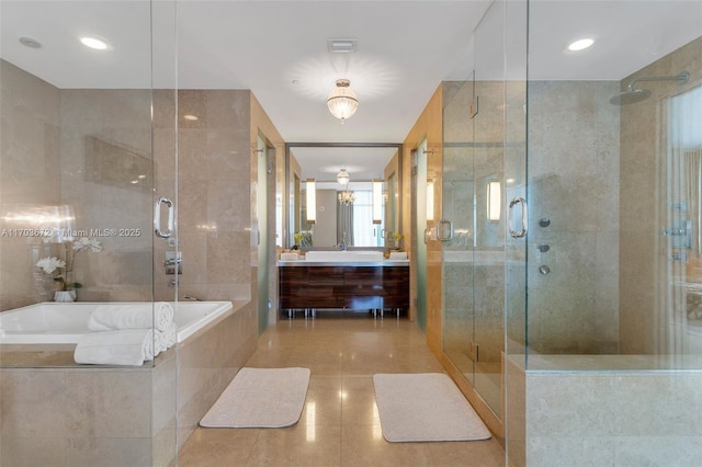 full bath with a stall shower, vanity, a garden tub, and tile patterned floors