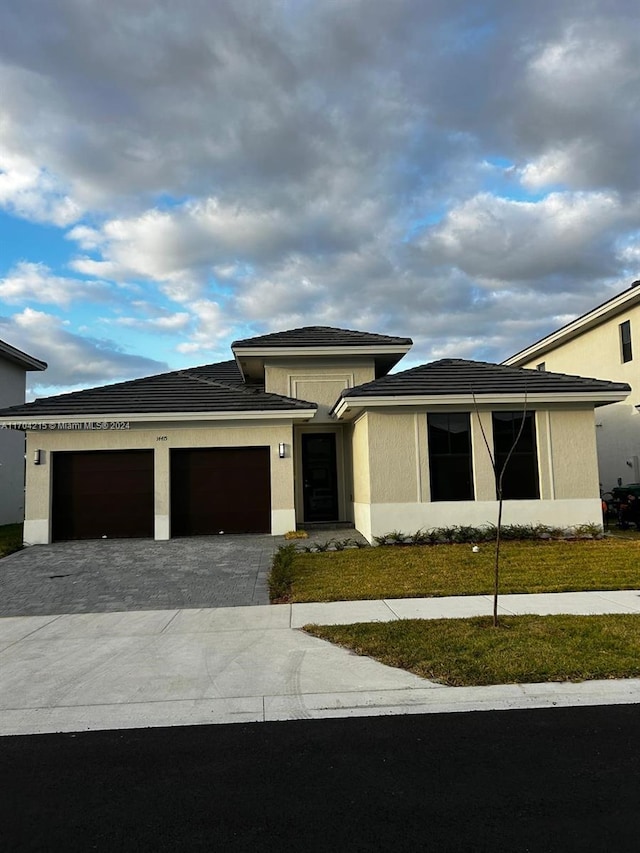 prairie-style house with a front yard and a garage