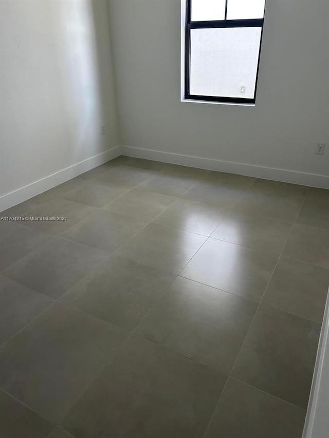 unfurnished room with tile patterned floors