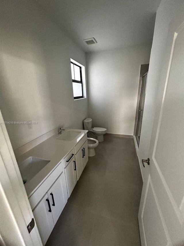 bathroom with vanity, a bidet, a shower with shower door, and toilet