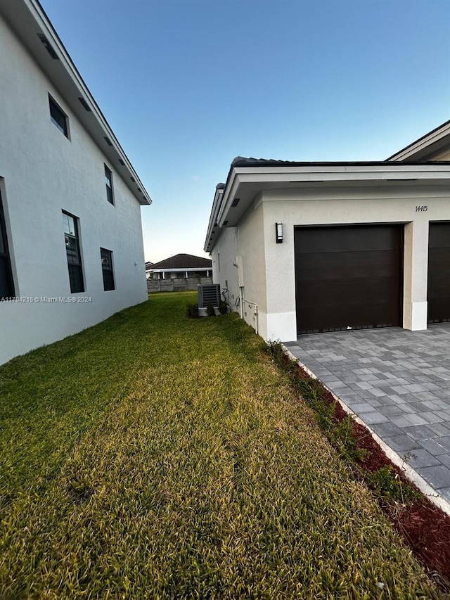 view of home's exterior with central AC unit and a yard