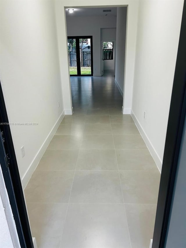 corridor featuring light tile patterned floors