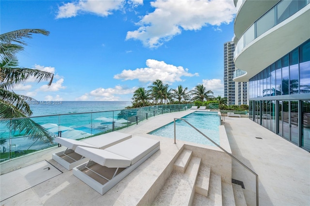 view of swimming pool featuring a water view