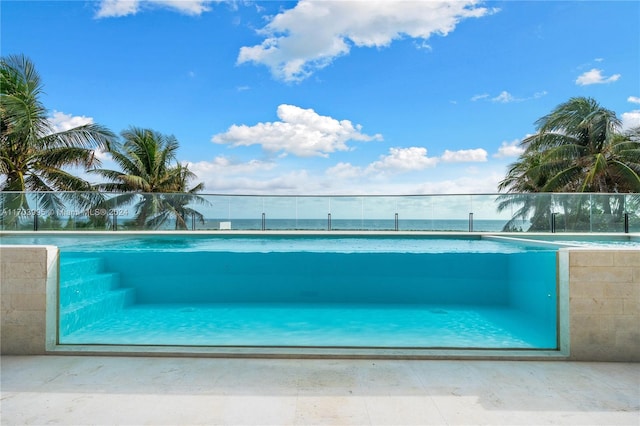 view of swimming pool with a water view