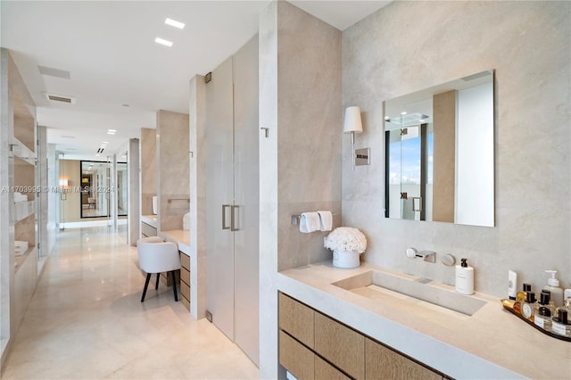 bathroom featuring vanity, walk in shower, and concrete floors