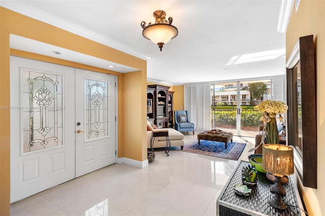 entryway with crown molding, french doors, and light tile patterned flooring