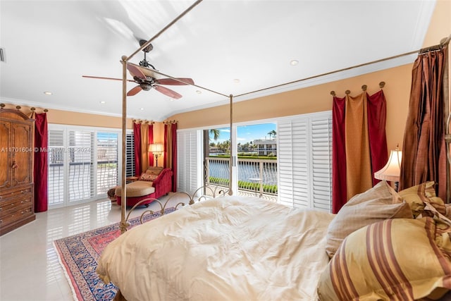 bedroom with access to exterior, a water view, and multiple windows