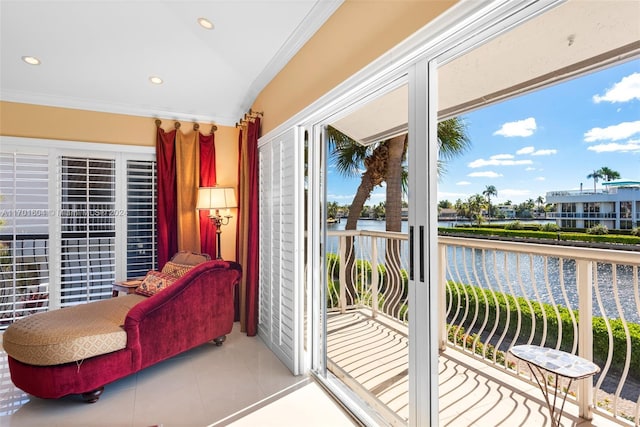 doorway featuring crown molding, a water view, and light tile patterned flooring