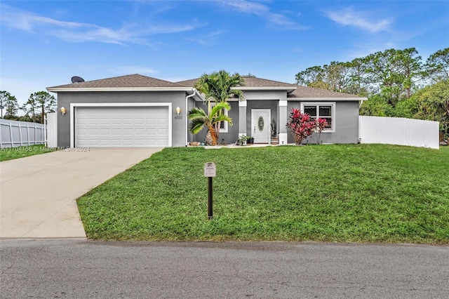 ranch-style home featuring a garage and a front yard