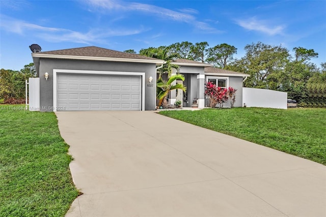 view of front of property with a front lawn and a garage