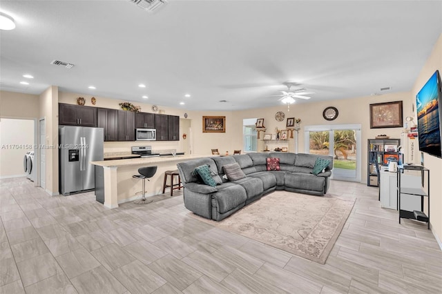 living room with washer / clothes dryer and ceiling fan