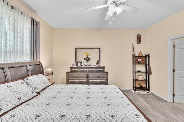 bedroom featuring light hardwood / wood-style floors and ceiling fan