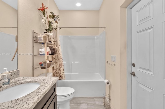 full bathroom with hardwood / wood-style flooring, vanity, toilet, and washtub / shower combination