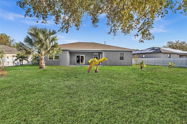 rear view of property with a lawn