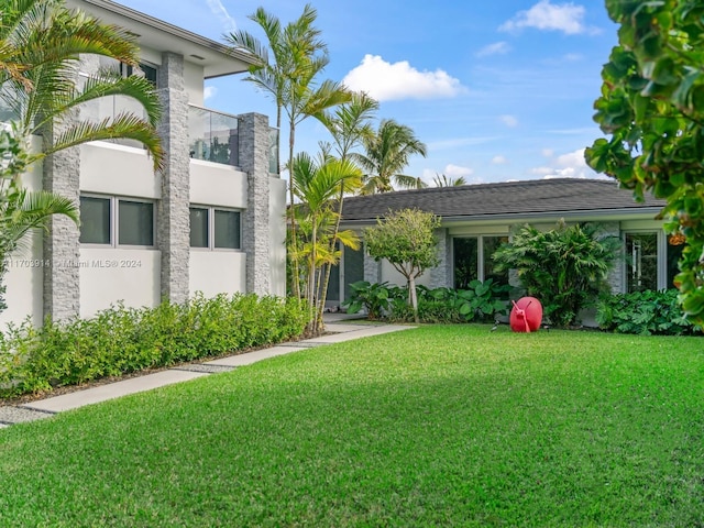 9301 N Bayshore Dr, Miami Shores, FL 33138 - view of front of home featuring a front yard and stucco siding