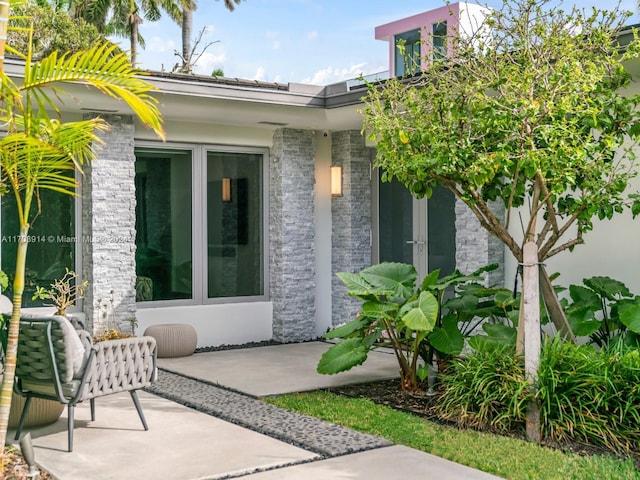 entrance to property featuring a patio