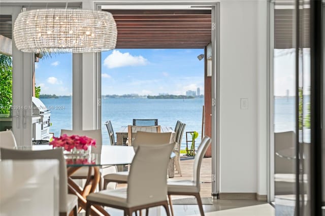 9301 N Bayshore Dr, Miami Shores, FL 33138 - dining area with a water view and baseboards
