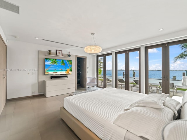 bedroom featuring access to outside, french doors, and light tile patterned floors