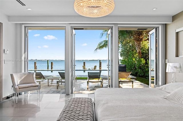 bedroom featuring access to outside and a water view