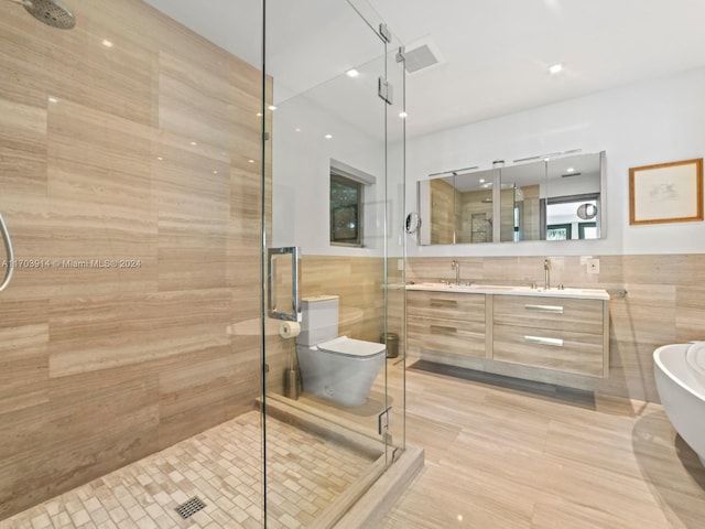 bathroom with plus walk in shower, vanity, and tile walls