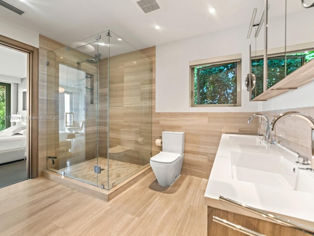 9301 N Bayshore Dr, Miami Shores, FL 33138 - ensuite bathroom featuring double vanity, a stall shower, tile walls, and recessed lighting