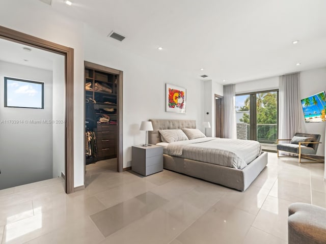 9301 N Bayshore Dr, Miami Shores, FL 33138 - bedroom featuring light tile patterned flooring, a spacious closet, and recessed lighting