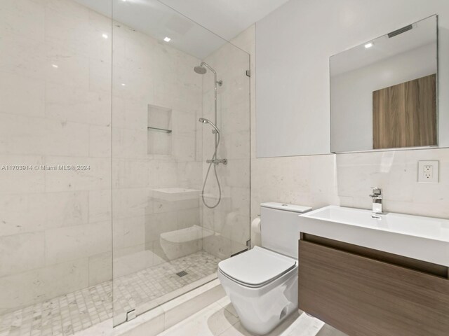 9301 N Bayshore Dr, Miami Shores, FL 33138 - full bathroom with vanity, tiled shower, and tile walls