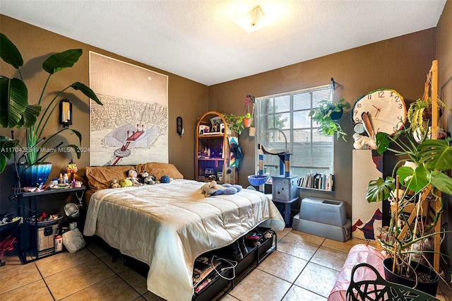 bedroom with light tile patterned floors and a textured ceiling