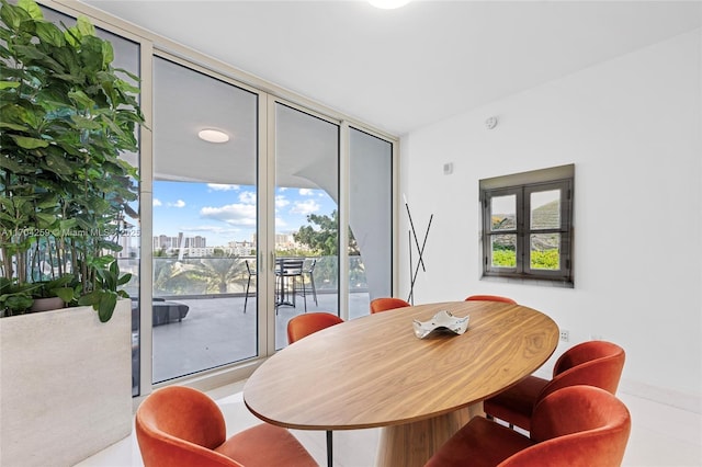 dining space with a city view and floor to ceiling windows