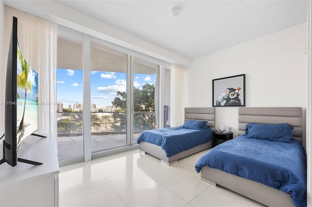 bedroom with light tile patterned floors and access to exterior