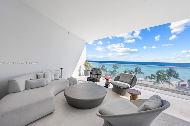 balcony featuring a beach view, a water view, and an outdoor hangout area