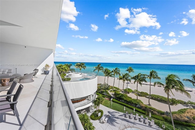 balcony featuring a water view and a view of the beach