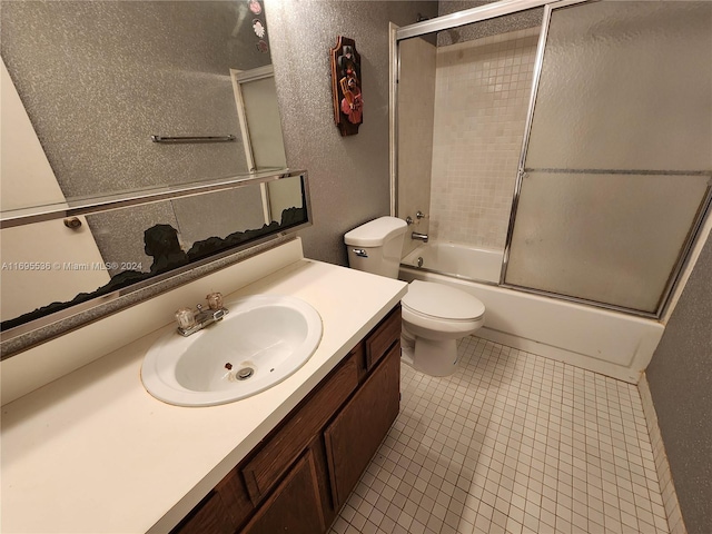 full bathroom with tile patterned flooring, vanity, toilet, and enclosed tub / shower combo